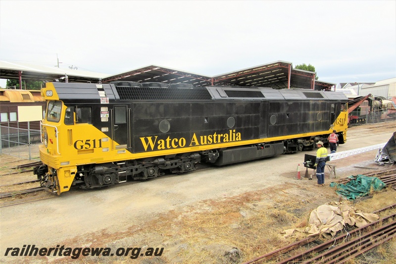 P15656
Watco Australia loco G class 511 in the yellow and black livery passing through the site of the Rail Transport Museum heading towards UGL's plant in Bassendean, side and trailing end view
