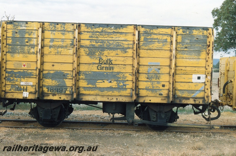 P15700
GH class 18997, planked high sided open wagon with the side doors replaced with planking, yellow livery, Pinjarra, SWR line, non brake lever side view 
