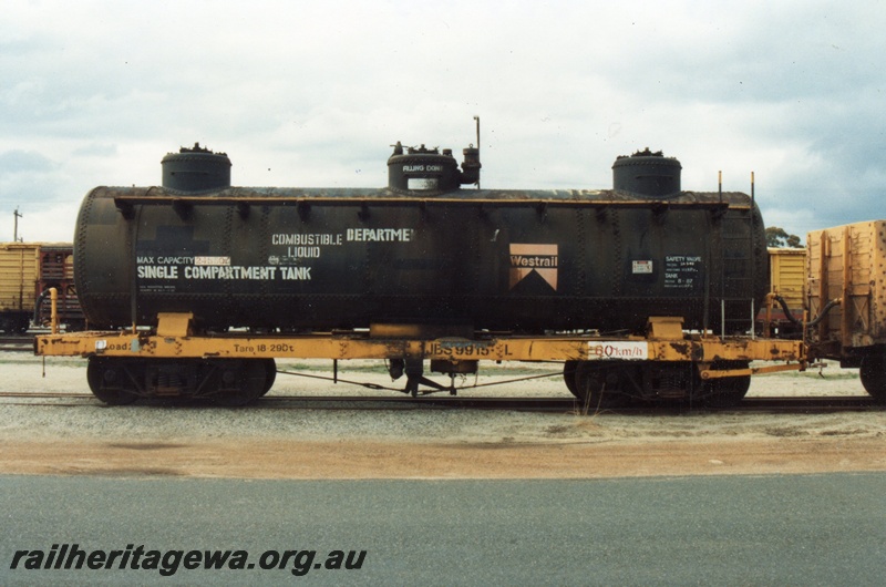 P15749
JBS class 9915-L bogie tank wagon, black three dome tank on a yellow underframe, Midland, side view
