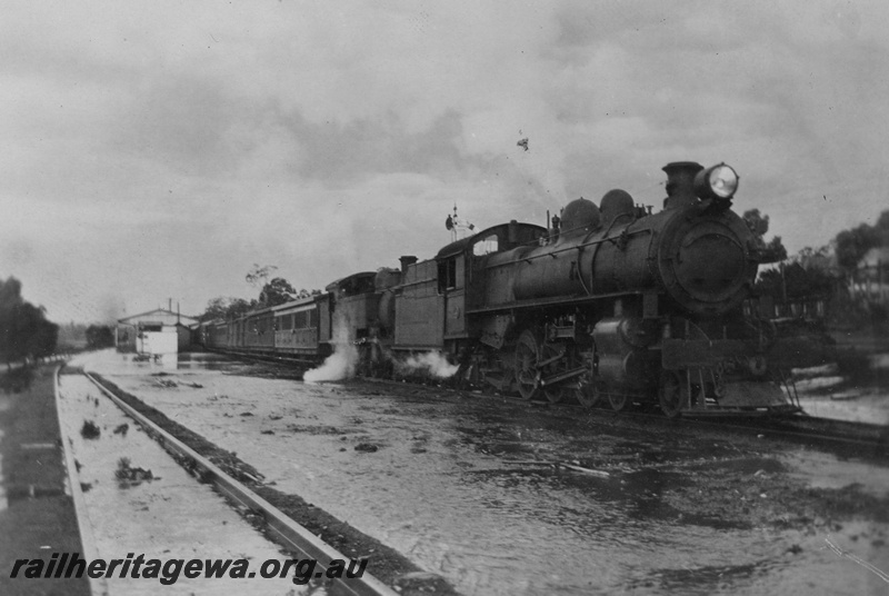 P15763
P class loco double heading with a D class tank loco, passenger train, station buildings, Bakers Hill, ER line, train held up due to sand washed onto the line and flooding 
