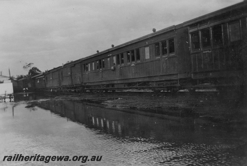 P15764
Passenger train, station buildings, Bakers Hill, ER line, train held up due to sand washed onto the line and flooding 
