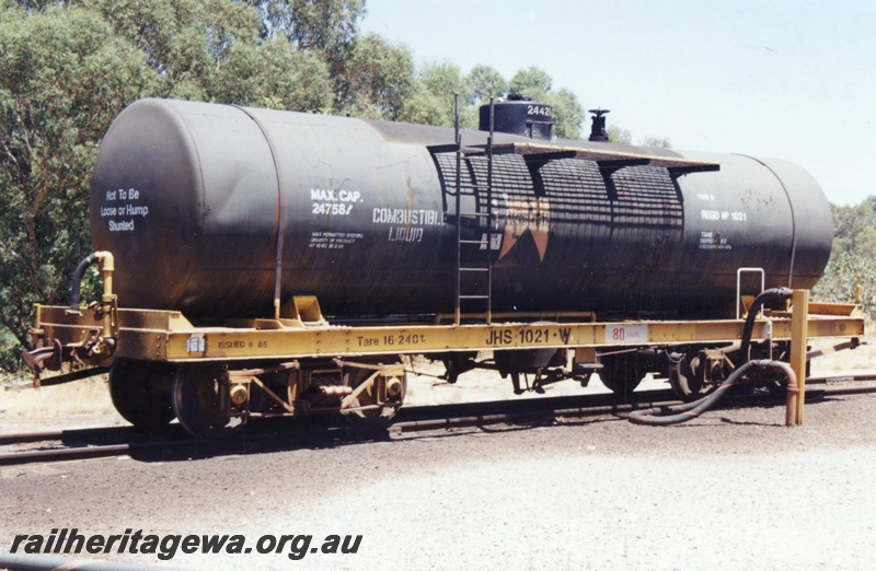 P15766
JHS class 1021 bogie tank wagon, black tank with a yellow underframe, Westrail insignia on the side, Midland, end and side view.
