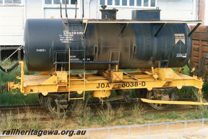 P15775
JOA class 8038-D four wheel tank wagon, black tank on a yellow underframe, 