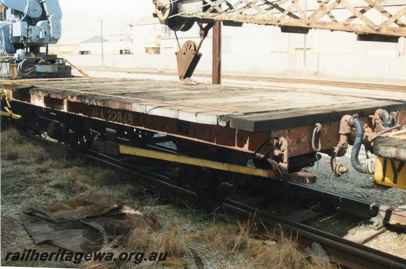 P15800
4 of 5 views of NFA class 22849 four wheel flat wagon being used as a match truck for a steam crane at Midland, brown livery but with a yellow brake lever, side and end view of the deck, side sill, headstock and brake equipment
