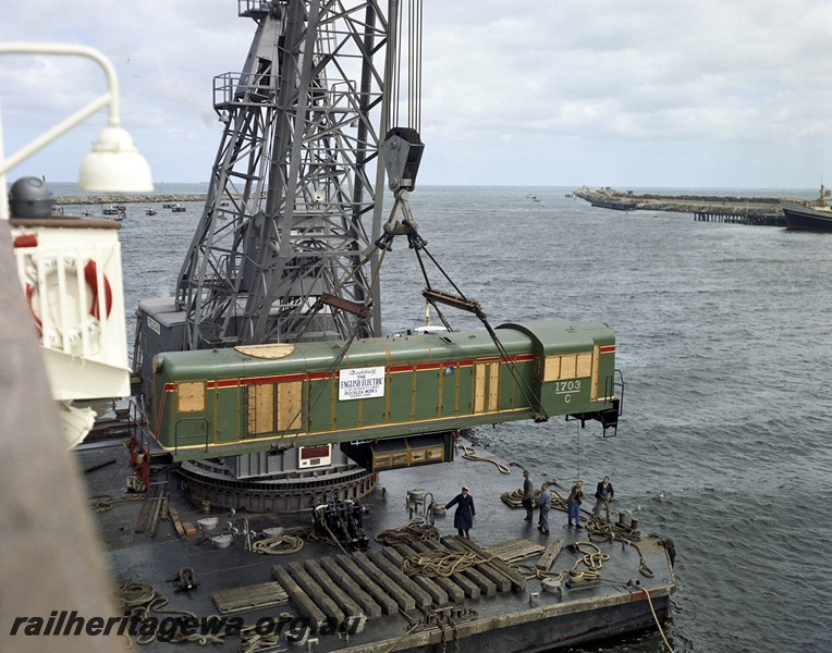 P15840
C class 1703 in the green with the red and yellow stripe livery being unloaded from the ship 