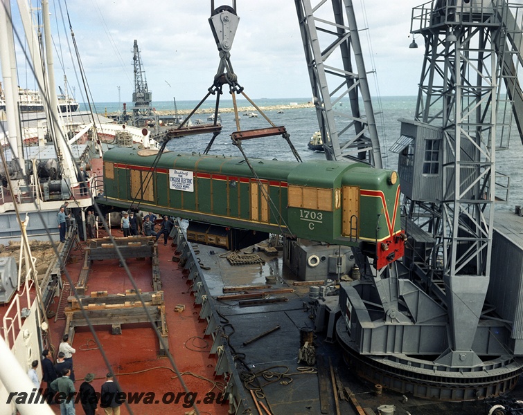 P15844
C class 1703 in the  green with the red and yellow stripe livery being unloaded from the ship 