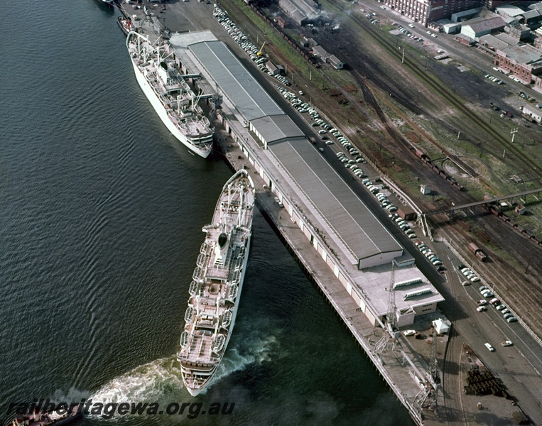 P15855
Turntable, footbridge, loco depot, yard, aerial view, Fremantle, ship departing the passenger terminal, Victoria Quay, Fremantle Harbour. c1963
