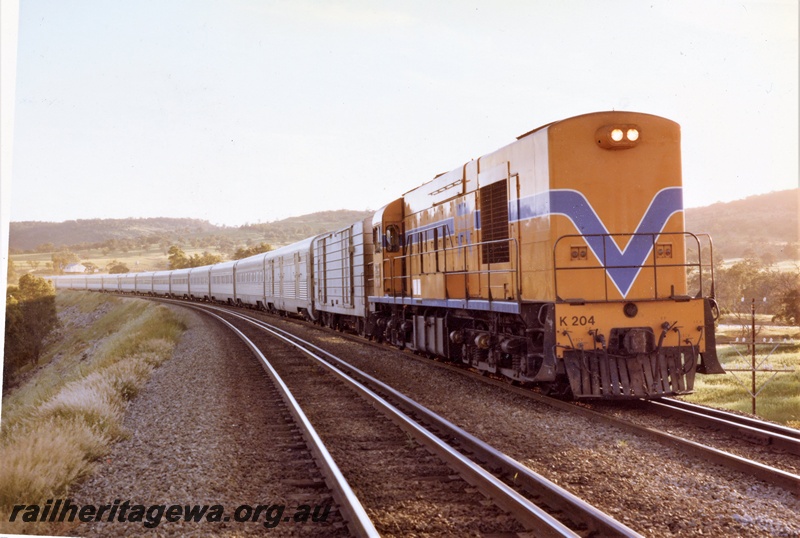 P15866
K class 204, in Westrail orange with blue and white stripe, heading passenger train of stainless steel cars, Avon Valley line, similar to P3187, side and front view
