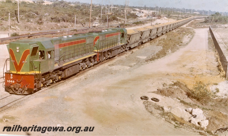 P15880
D class 1562, with another diesel loco, both in green with red and yellow stripe livery, double heading bauxite train, rural setting, front and side view
