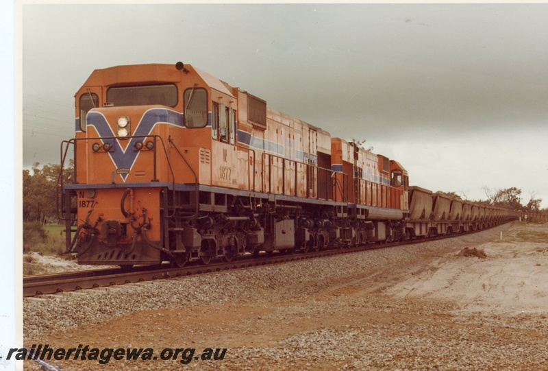 P15892
N class 1877 and another diesel loco, in Westrail orange with blue and white stripe, double heading bauxite train, rural setting, front and side view
