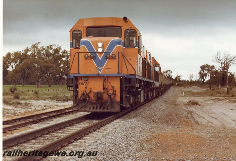 P15893
N class 1877 and another diesel loco, in Westrail orange with blue and white stripe, double heading bauxite train, rural setting, front and partial side view
