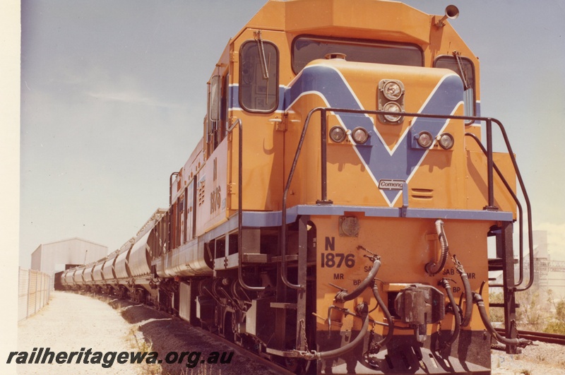 P15897
N class 1876, in Westrail orange with blue and white stripe, on bauxite train being unloaded, side and front view
