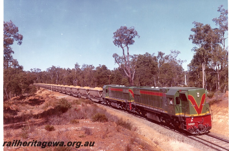 P15923
D class 1562, and another diesel loco, both in green with red and yellow stripe livery, double heading bauxite train, rural setting, side and front view, similar to P0273

