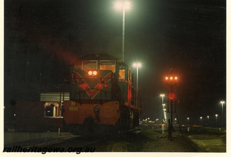 P15926
M class 1851,in green with red and yellow stripe livery, signal lamps, light towers, Forrestfield Hump Yard, at night, front and side view
