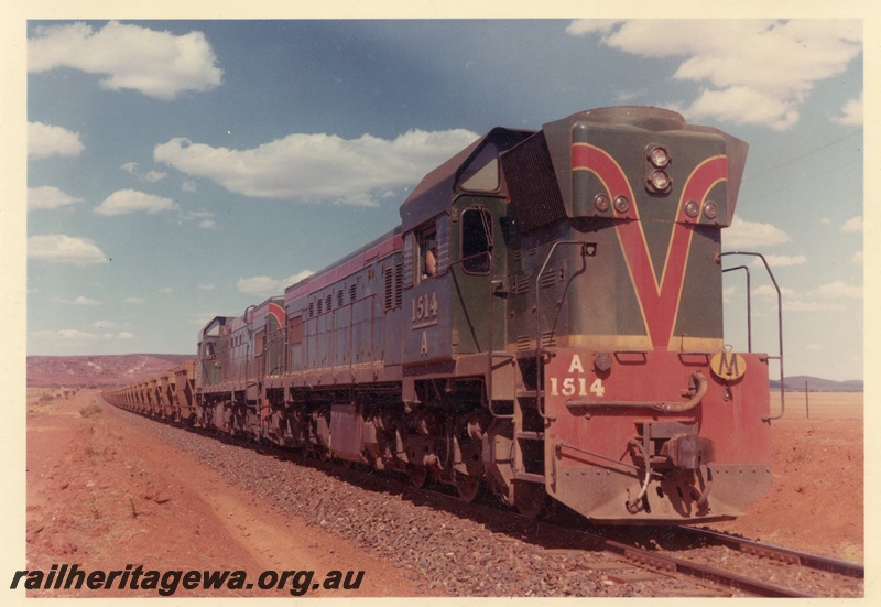 P15930
A class 1514, with A class 1513 diesel loco, in green with red and yellow stripe, double heading loaded WMC iron ore train from Koolanooka, side and front view

