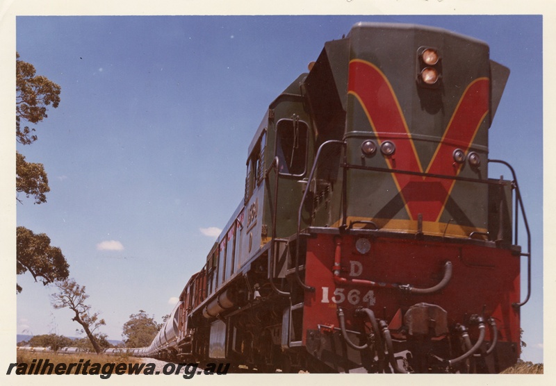 P15949
D class 1564, in green with yellow and red stripe livery, on goods train to Kwinana, side and front view
