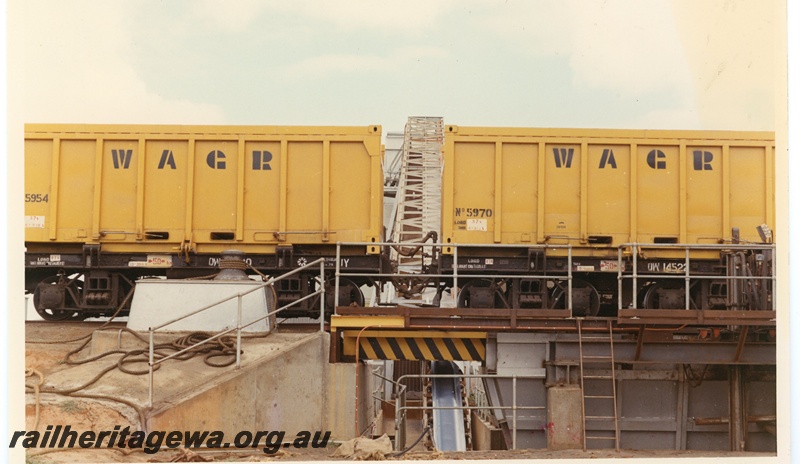 P15956
QW class 14522 converted mineral sands wagon with container No. 5970, another converted mineral sands wagon with container No. 5954, unloading mineral sands, conveyor belt, Geraldton, side view 
