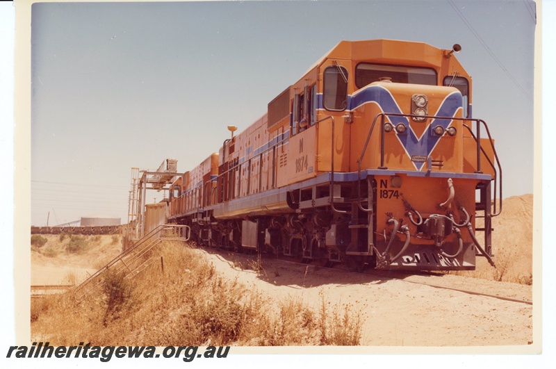 P15963
N class 1874, and another diesel loco, both in Westrail orange with blue and white stripe livery, double heading a goods train, side and front view
