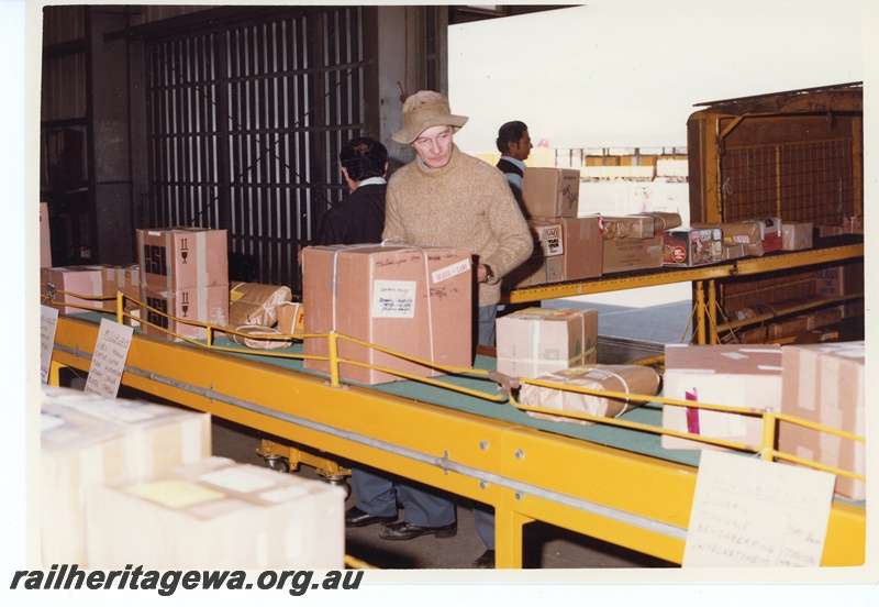 P15967
Parcel handling, conveyor belt, parcel handlers at work, truck being loaded, Kewdale Freight Terminal, interior view
