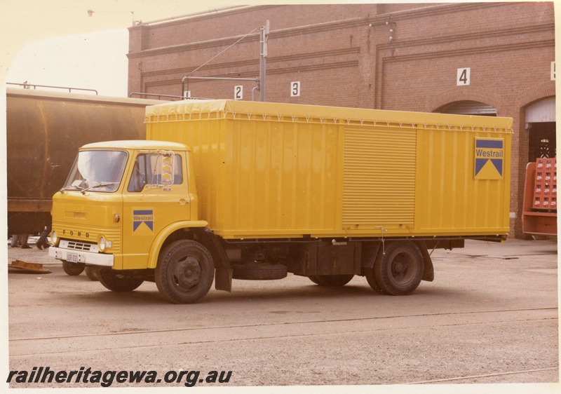 P15988
Westrail Ford truck, licence no UOR032, in yellow and blue colour scheme, Midland Workshops, front and side view
