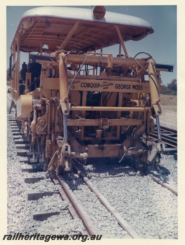 P15995
Plassermatic ballast tamper, distributed by Conquip in association with George Moss, on dual gauge track, front view 
