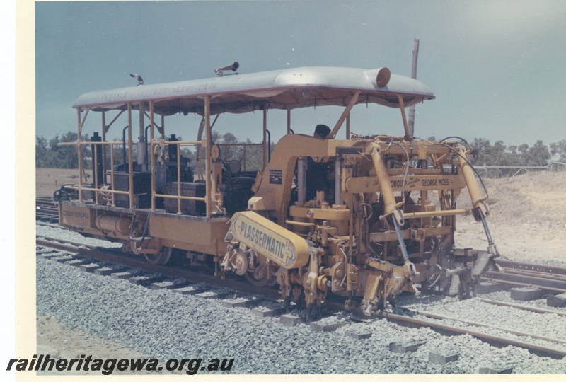 P15996
Plassermatic ballast tamper, distributed by Conquip in association with George Moss, on dual gauge track, side and front view 
