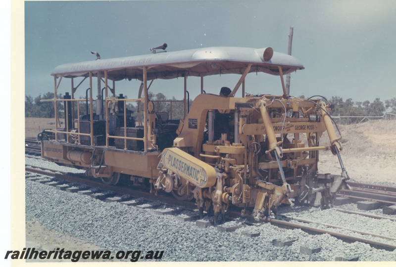 P15996
Plassermatic ballast tamper, distributed by Conquip in association with George Moss, on dual gauge track, side and front view 
