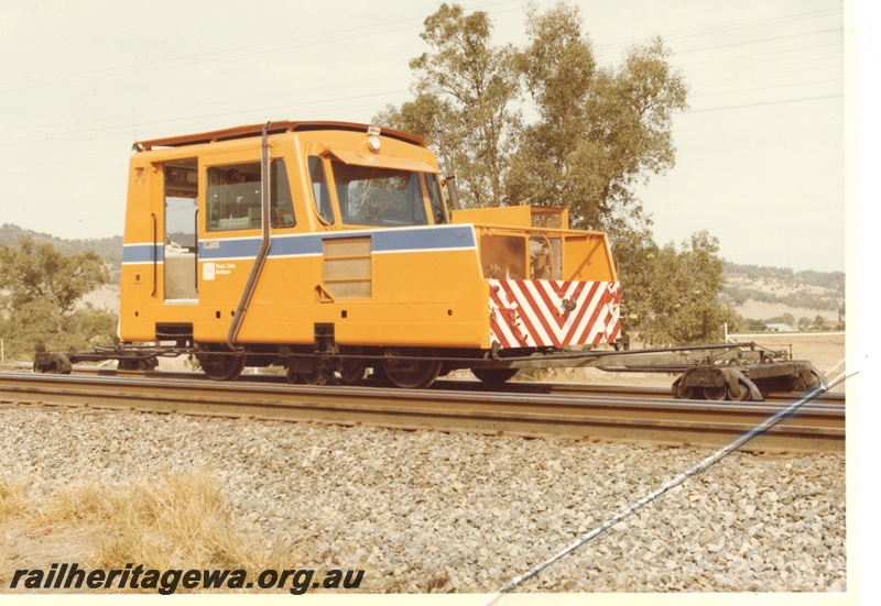 P16002
Mobile track data analyser, in yellow with blue and white stripe, red and white chevrons on front end, side and front view
