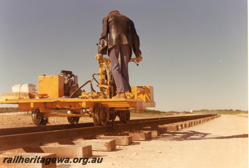 P16003
Motorised trolley, with mechanical sleeper spike inserter, operator, rear and side view
