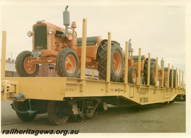 P16021
WF class 30045, flat wagon, yellow, loaded with orange Chamberlain Champion 56 tractors, later reclassified to WFDY and others, end and side view,
