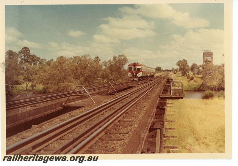 P16036
Three rail car set headed by ADG class, in red, white and green livery, crossing wooden trestle bridge over Swan River, Guildford, ER line

