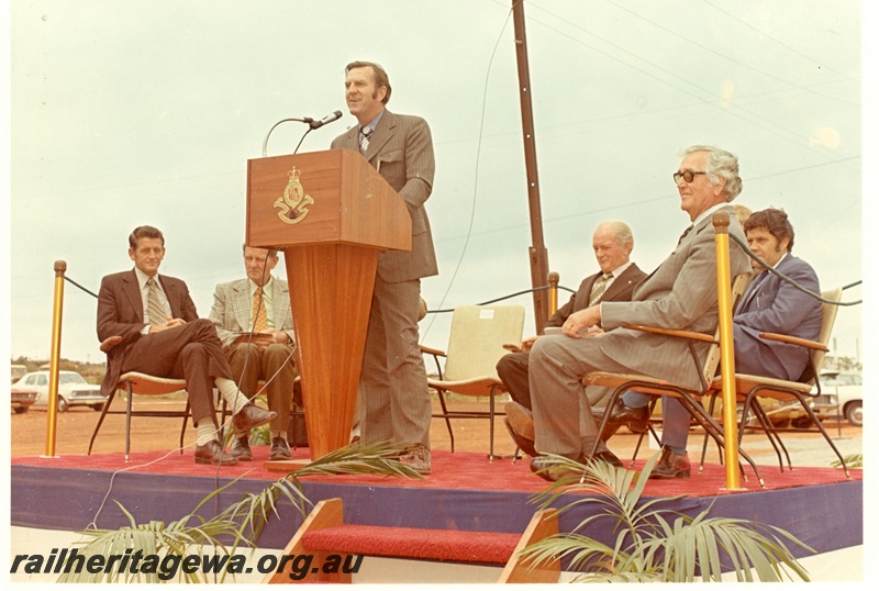 P16063
Minister for Railways, Ray O'Conner, with Commissioner of Railways R. J. Pascoe sitting at the rear, and other dignitaries, at an official launch. 
