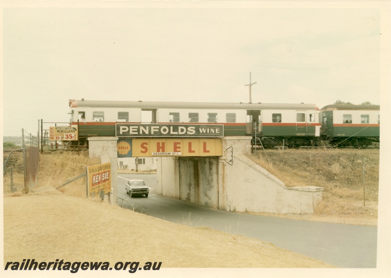 P16083
A suburban railcar set travelling over the Shenton Park subway. Advertising 