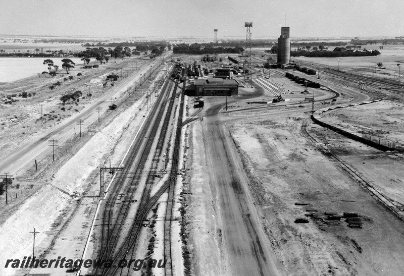 P16088
West Merredin yard, an overhead view, showing the narrow gauge yard to the left and the standard gauge yard to the right. The freight terminal is the middle foreground with the Yardmaster's Building behind and the CBH Transfer silos to the right. Great Eastern Highway is to the left.
