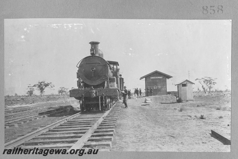 P16159
Commonwealth Railways (CR), steam locomotive, on visitors train from Kalgoorlie to view construction of the Trans Australian Railway, station building, corrugated iron toilet, Randalls, TAR line, front view, c1917
