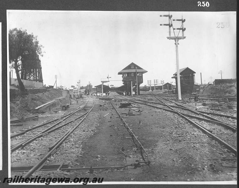 P16165
Commonwealth Railways (CR), double tank water tower, trackwork, rodding, signal boxes, multiple bracket signals, platform and canopy, Kalgoorlie, TAR line
