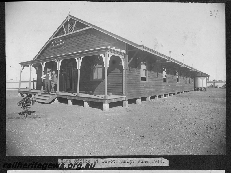 P16169
Commonwealth Railways (CR), head office building, weatherboard, with two men on front veranda, Kalgoorlie depot, TAR line
