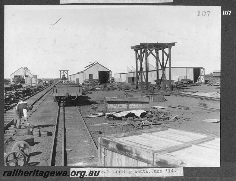 P16173
Commonwealth Railways (CR), Kalgoorlie depot, sheds, worker, wagons, wheels, crates, wooden loading gantries, Kalgoorlie, TAR line, view looking south
