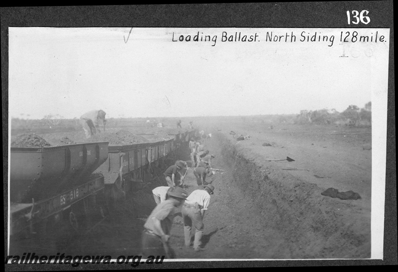 P16175
Commonwealth Railways (CR), rake of ballast wagons including BS class 518, being manually loaded by workers, north siding, 128 mile, TAR line c1914
