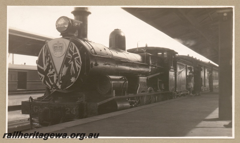 P16188
Commonwealth Railways (CR), GA class 24, decorated with British and Australian flags and royal insignia, on the special train carrying the Duke of Gloucester, Kalgoorlie station, TAR line, front and side view
