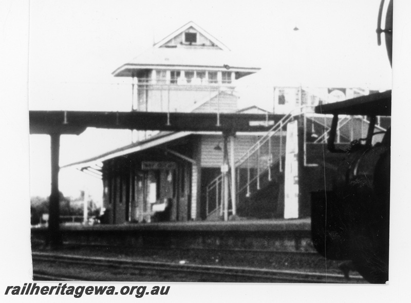 P16212
Station building, signal box, platform, overhead footway, Bassendean, ER line, track level view
