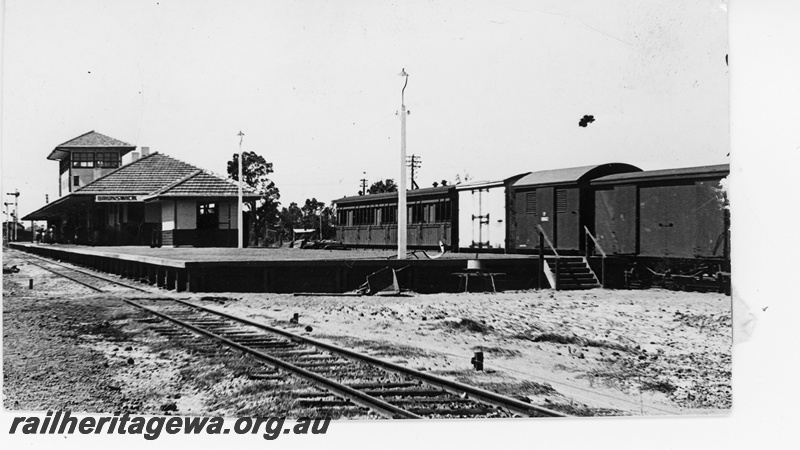 P16217
Bracket signal, station building, signal box, platform, passenger carriage, vans, Brunswick Junction, SWR line, track level view
