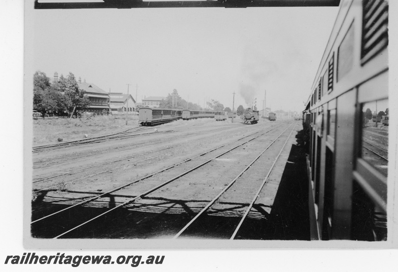 P16221
Yard, rakes of passenger carriages, steam loco, bracket signal, Midland Junction, ER line, view along train
