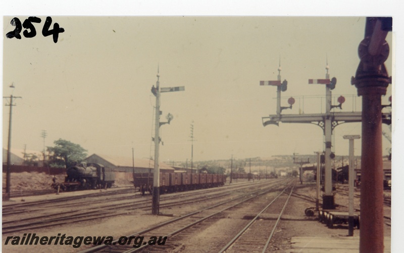 P16241
Station yard, steam loco, rake of wagons, signal, bracket signal, water tower, Northam, ER line, view from east end of station platform
