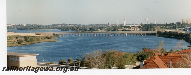 P16262
Goongoongup rail concrete and steel bridge over Swan River, old wooden Bunbury bridge behind it, WACA ground lights, East Perth, SWR line, distant view, c1995
