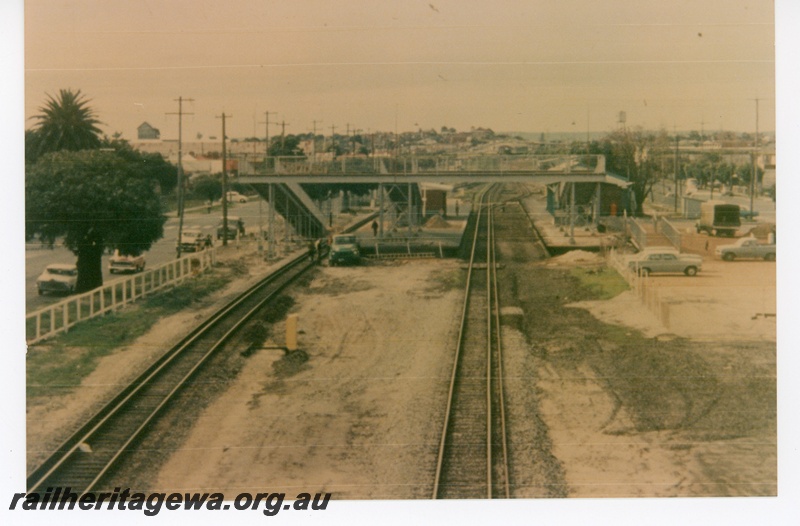 P16268
Overview of Maylands station, dual gauge track, overhead footbridge, station building, platform, Maylands, ER line, elevated view

