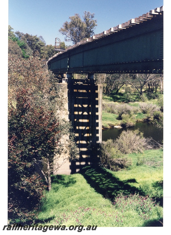 P16278
3 of 5. A partial below bridge view showing the open nature of under rail portion. The steel section of the girders are visible.
