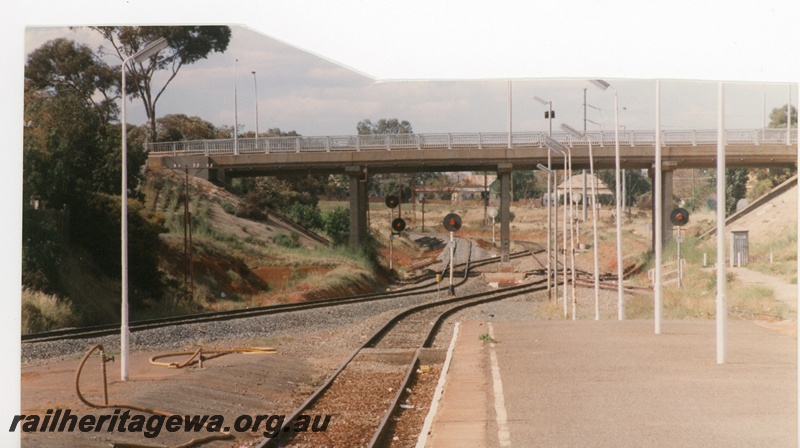 P16295
Kalgoorlie Station platform looking east to Maritana Street bridge. Passenger main line in foreground while freight main line is to left.
