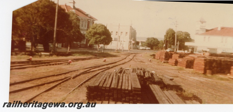 P16301
Midland Railway Company's yard at Midland looking east towards the Helena Street and Great Eastern Highway level crossing. The former Midland Post Office is the building on the left amongst the trees. Midland Centrepoint Shopping Centre now occupies this site.
