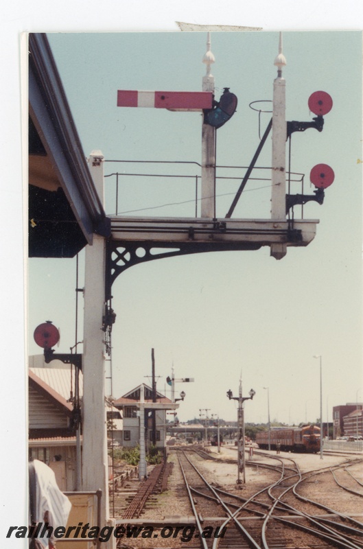 P16331
X class loco in Westrail orange with blue and white stripe livery on passenger train, bracket signals, signal box, rodding, crossover, Perth
